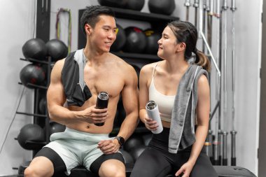 Asian men and women Have a strong body, good health, love to exercise. They are exercising together at the gym having fun.	