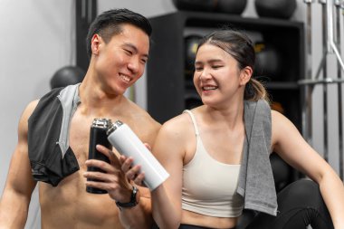 Asian men and women Have a strong body, good health, love to exercise. They are exercising together at the gym having fun.	