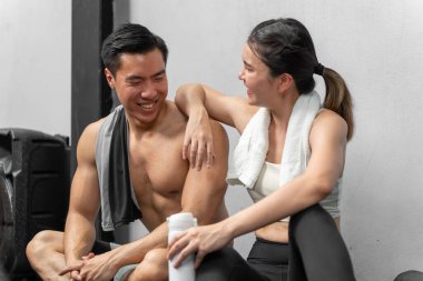 Asian men and women Have a strong body, good health, love to exercise. They are exercising together at the gym having fun.	