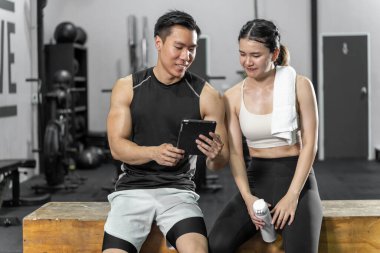 Asian men and women Have a strong body, good health, love to exercise. They are exercising together at the gym having fun.	