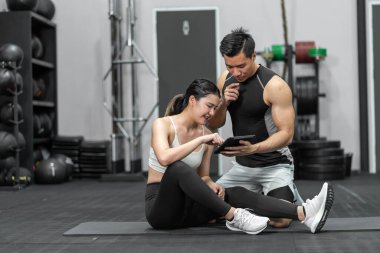 Asian men and women Have a strong body, good health, love to exercise. They are exercising together at the gym having fun.	