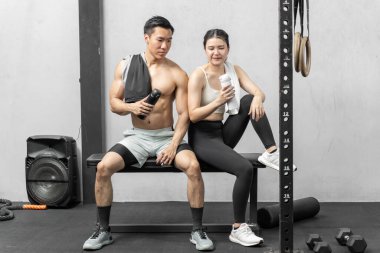 Asian men and women Have a strong body, good health, love to exercise. They are exercising together at the gym having fun.	