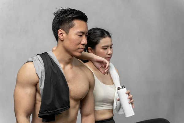 Asian men and women Have a strong body, good health, love to exercise. They are exercising together at the gym having fun.	