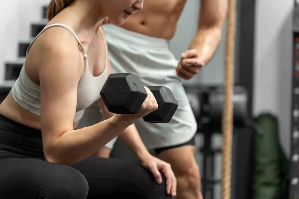 Asian men and women Have a strong body, good health, love to exercise. They are exercising together at the gym having fun.	