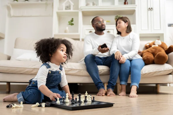 African family, father, mother, daughter doing various activities together on holiday or family day in house or neighborhood, happily.