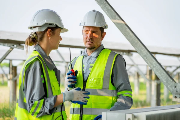 Electrical engineer on solar farm with large structure Check maintain rehearse damaged parts from use in order to produce electricity with maximum efficiency throughout its service life professionally