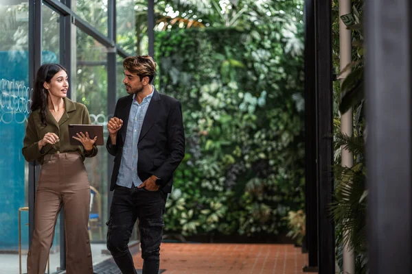 stock image business partners walking down in office building and talking