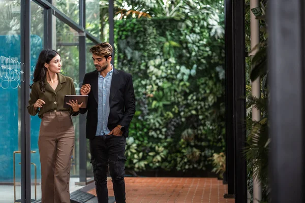 stock image business partners walking down in office building and talking