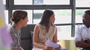 Modern bir ofiste fikirleri tartışan genç iş adamlarının görüntüleri. 