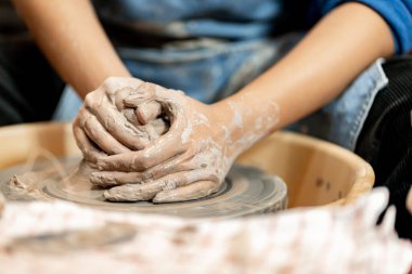 Toprak kaplama. Çamur yontma sanatı. Seramik el ile şekillendiriliyor. Profesyonel olarak bir tabak ya da vazo yaratmak için doğru duruş ile