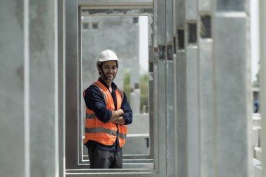 Male engineers are inspecting and controlling the work of the employees and the quality of the manufactured products to meet the standards In industrial factories producing precast prefabricated walls