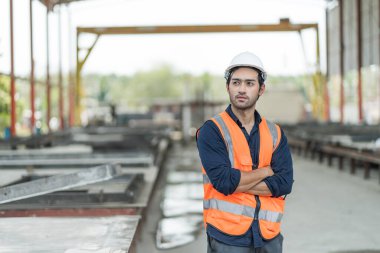 Male engineers are inspecting and controlling the work of the employees and the quality of the manufactured products to meet the standards In industrial factories producing precast prefabricated walls