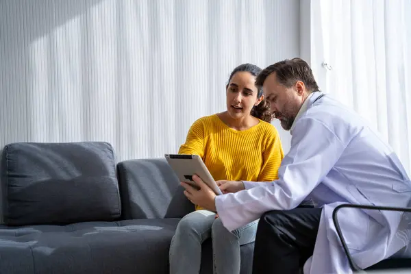 stock image male  doctor and Female patient Talk and give advice about the illnesses of patients in the hospital