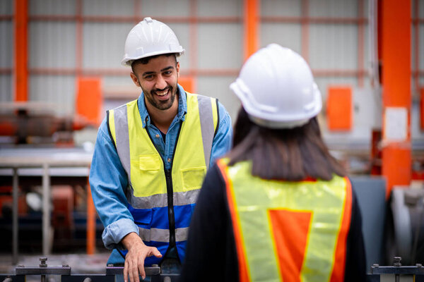 Young male engineer in metal sheet factory Responsible work is being inspected at the actual work site. Work professionally and happily