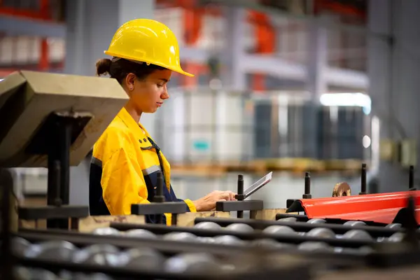 Team of young male and female engineers in a metal sheet factory Responsible work is being inspected at the actual work site. Work professionally and happily