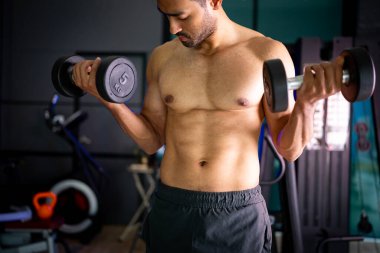 A strong Asian man is exercising to build muscle.	