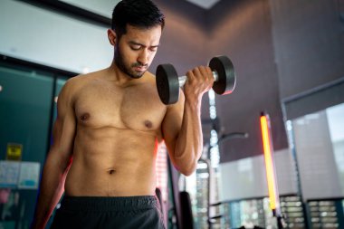 A strong Asian man is exercising to build muscle.	