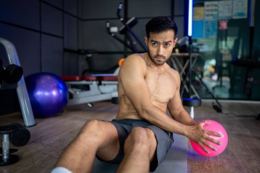 A strong Asian man is exercising to build muscle.	