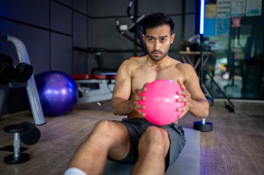 A strong Asian man is exercising to build muscle.	