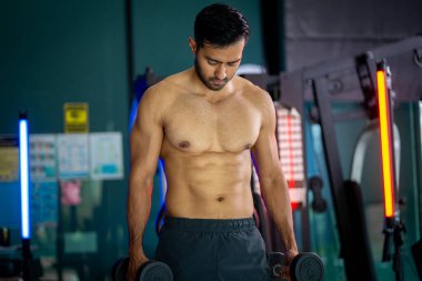 A strong Asian man is exercising to build muscle.	