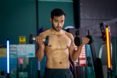 A strong Asian man is exercising to build muscle.	