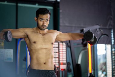 A strong Asian man is exercising to build muscle.	