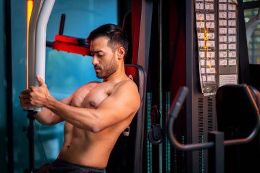 A strong Asian man is exercising to build muscle.	