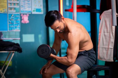A strong Asian man is exercising to build muscle.	