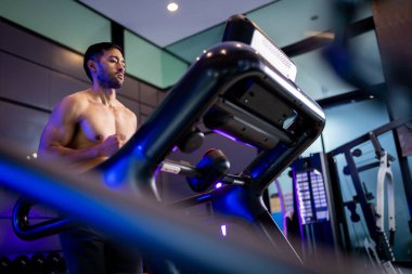 A strong Asian man is exercising to build muscle.	