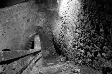 Viterbo, İtalya 'da geceleri antik taş duvarlarla çevrili yokuş aşağı bir yol esiyor. Yumuşak parıltı, bu büyüleyici bölgenin tarihsel atmosferini güçlendiriyor..