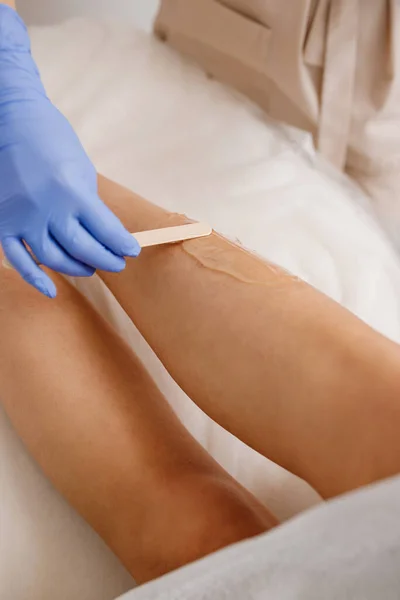 Close up of hair removing procedure on legs. Laser epilation and cosmetology in beauty salon