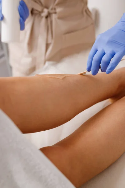 Close up of hair removing procedure on legs. Laser epilation and cosmetology in beauty salon
