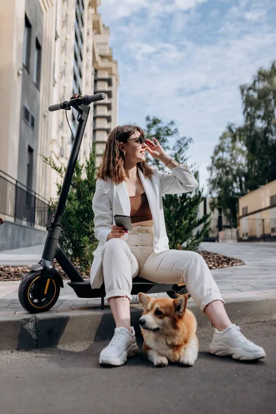 Young Businesswoman White Suit Sitting Electric Scooter Using Phone Walking — Fotografia de Stock