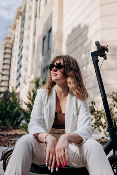 Young Businesswoman White Suit Sitting Electric Scooter Walking City Looking — Φωτογραφία Αρχείου