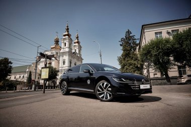 Vinnitsya, Ukraine - 14 July, 2022: Black Volkswagen Arteon R-Line in cityscape background 