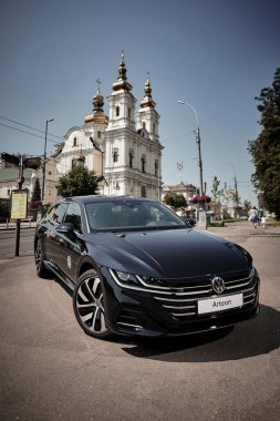 Vinnitsya, Ukraine - 14 July, 2022: Black Volkswagen Arteon R-Line in cityscape background  - front view