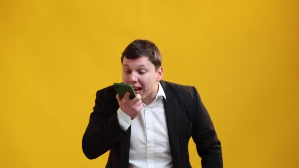 Angry Businessman Shouts Someone Phone Standing Yellow Studio Background — Video Stock
