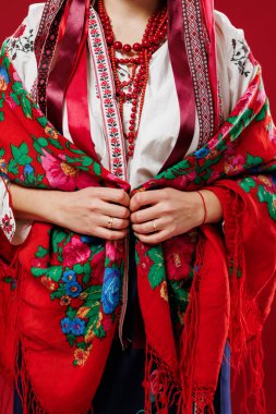 Close up of ukrainian woman in traditional ethnic clothing on viva magenta studio background. Ukrainian national embroidered dress call vyshyvanka. Pray for Ukraine