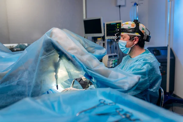 stock image Professional male surgeon proctologist performing operation using special medical devices in the operating room in hospital. Urgent surgical concept