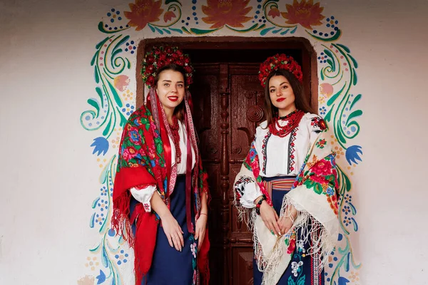 Two Ukrainian Women Traditional Ethnic Clothing Floral Red Wreath Background — Stockfoto