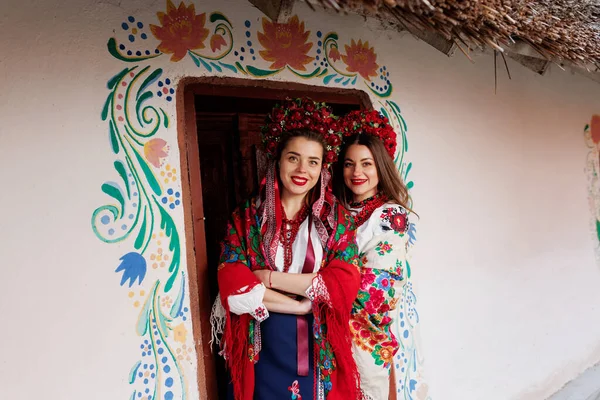 Two Ukrainian Women Traditional Ethnic Clothing Floral Red Wreath Background — Stockfoto
