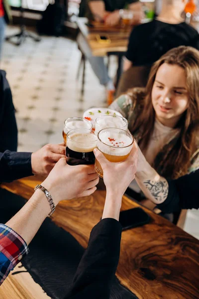 stock image Friends hands toasting and having fun together drinking beer and cocktails at happy hour in pub restaurant . Social life style party time concept