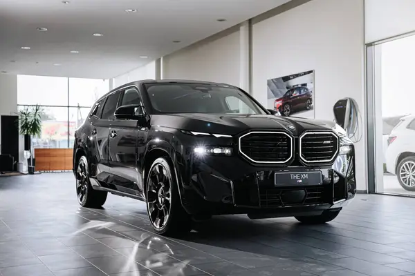 stock image Vinnitsya, Ukraine - May 18, 2023 : BMW XM - Luxury car fully electric edrive technology in plug-in hybrid system presentation in showroom - side view