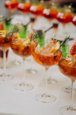 Bir etkinlikte kokteyl bardakları ve içkilerle hoş geldin içkisi. Düğün masasında alkollü içecekler.