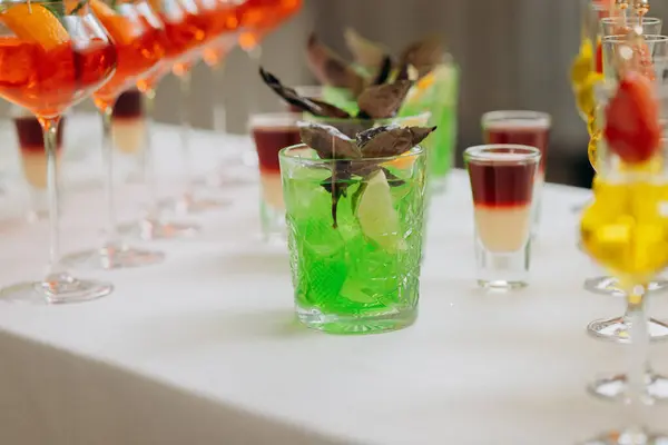Welcome drink with cocktail glasses and drinks at an event. Alcoholic beverages at a wedding table