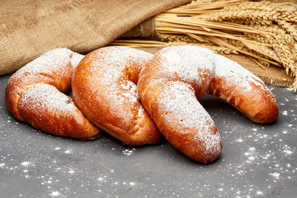 stock image Freshly baked crescent croissants sprinkled with powdered sugar on a rustic background. High quality photo