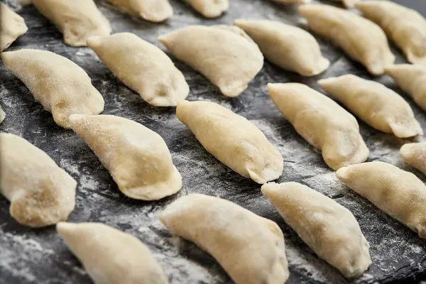 stock image Freshly prepared homemade dumplings ready for cooking, showcasing traditional culinary skills. High quality photo