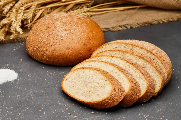 stock image Whole wheat bread loaf sliced, showcasing its hearty texture and rich, wholesome flavor. High quality photo