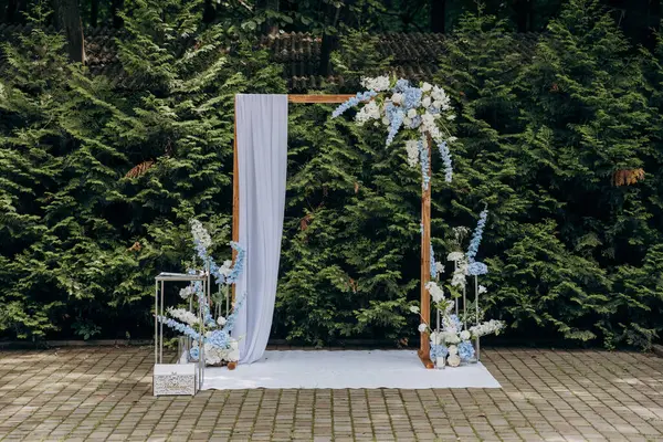 stock image Elegant outdoor wedding arch with floral decorations for a romantic garden ceremony. High quality photo