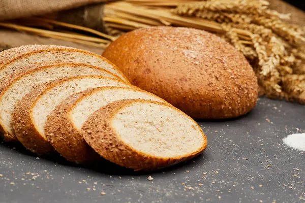 stock image Whole wheat bread loaf sliced, showcasing its hearty texture and rich, wholesome flavor. High quality photo